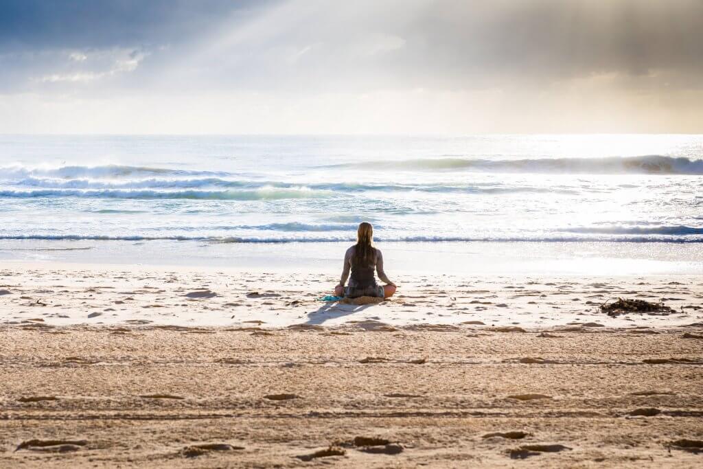 Woman relaxing on the beach after finally getting anxiety treatment. In Scotch Plains, NJ you too can get help for anxiety at Brave Minds Psychological Services. She is looking at the waves, sitting on the sand and feeling calm and peace for her life. Westfield, Cranford and Fanwood adults can get help for anxiety today!