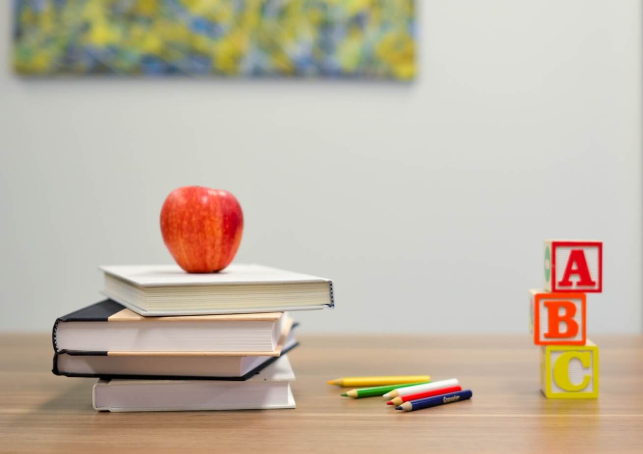 School books, pencils and blocks on a new desk at a new school