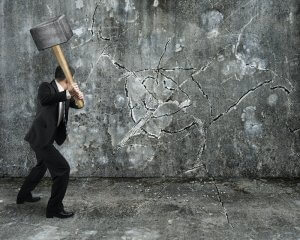 businessman using sledgehammer cracking wall broken on concrete floor background. Therapy for anxiety in westfield, nj and scotch plains therapy for anxiety and rage can help you heal.