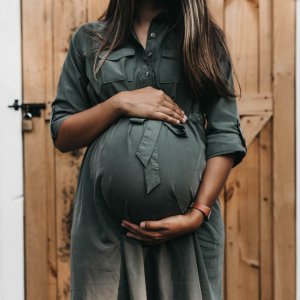 mother holding her pregnant belly