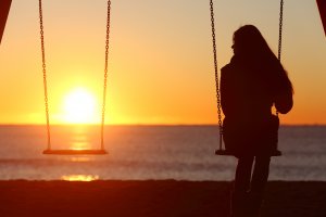 Woman on a swing looking at the sunset. Anxious women can get CBT Therapy Westfield, NJ at Brave Minds Psychological Services in Scotch Plains, NJ