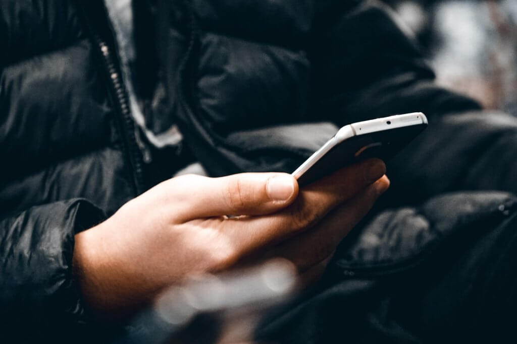 Photo of a phone where a person is texting a friend. Social-Distancing-in-New-Jersey-which-can-relieve-Anxiety