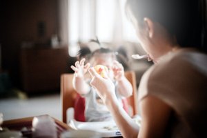 woman playing with her tiny child at the table. Can food allergies cause panic attacks? Yes! That's why anxiety therapy new jersey is great for parents of children and teens with food allergies new jersey. Westfield NJ counseling can help you cope with an anaphylactic reaction new jersey now.