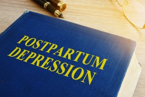 Book with title Postpartum depression on a table. Postpartum depression treatment in Cranford, Westfield and Fanwood, NJ is available for you!