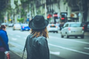 Woman in the city wearing a hat and carrying a bag feeling anxious. Looking at the street with busy people all around. Anxious women can get help in Fanwood, Westfield and Scotch Plains, NJ in Anxiety Therapy.