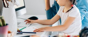 Mother and daughter sitting at the computer and phone trying to get through stressful times together. Online therapy in New Jersey or telehealth in New Jersey with the help of a child therapist in westfield, NJ can help!