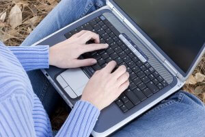 Person working on a laptop on the ground can do online therapy in New Jersey from anywhere! Caring online therapists in New Jersey help making coping with COVID 19 easier. Telehealth in New Jersey can help provide the help you need to heal.
