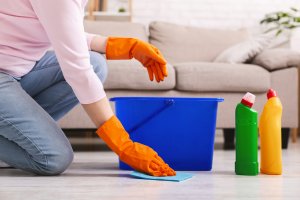 Woman with obsessive compulsive disorder cleaning floor with detergents at home. OCD Treatment in Westfield, NJ and OCD Treatment in Scotch Plains, NJ at Brave Minds Psychological Services Counseling Clinic. Online therapy in New Jersey is also available here!