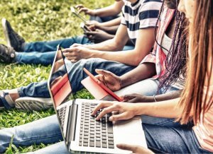 College students sit outside on the summer grass. They are on their laptops and tablets in order to virtually meet with their professors. Brave Minds Psychological Services offers online therapy for college students in New Jersey. We also offer therapy for teens, and child therapy online in new jersey.