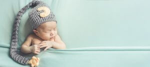 Adorable newborn baby sleeping in cozy room. Cute happy infant baby portrait with sleepy face in bed. Parents and moms of newborns need support postpartum in a pandemic. You can get birth trauma therapy or postpartum depression counseling in Cranford, NJ. Scotch Plains and Westfield, New Jersey 07076