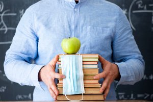 Teacher with face mask welcoming children back at school after lockdown. Back to school during COVID-19 pandemic for virtual learning during COVID. You can get anxiety treatment in Westfield, NJ and Anxiety treatment in Cranford, NJ with Brave Minds in Scotch Plains, NJ