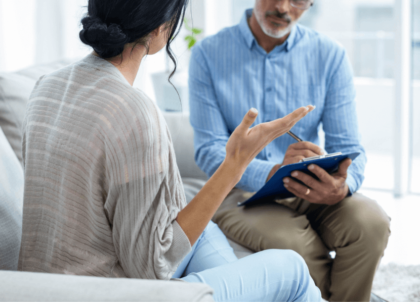 Mom talking to a child psychologist in New Jersey while sitting on a couch for parent counseling in union county, nj. You can get online therapy in new jersey for parent coaching in Scotch Plains, Westfield, Cranford and beyond.