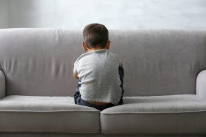 Little boy sitting with back to the camera, worried and scared. Child anxiety therapy in Scotch Plains, NJ can help with scary thoughts.