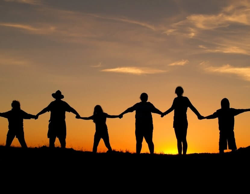 Unity and strength of a family holding hands in the sunset. Symbolizing the love languages for children and teens with anxiety for child therapy and teen therapy in Scotch Plains, NJ. You can get help with parent coaching and therapy for children with anxiety here and via online therapy in New Jersey