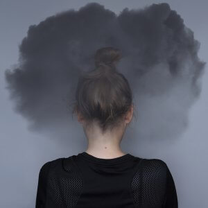 Woman with a dark cloud around her head after EMDR therapy with a client suffering from PTSD in Scotch Plains, NJ. You can get help for trauma therapy from a skilled online therapist in New Jersey with a Scotch Plains, NJ therapist here!