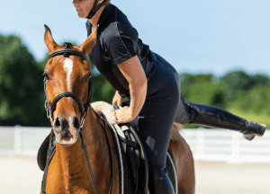 A rider mounts her horse with an uncomfortable look on her face as her leg sweeps around the saddle of the horse. This expression could represent the anxiety that comes from horseback injuries. We offer trauma therapy in Scotch plains, NJ to support you through events such as this. Contact a trauma therapist for support today. 