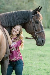 Lisa Weiss, equestrian mental health therapist in NJ, standing next to her horse, Beau