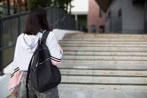 teen walks on outdoor stairs with her backpack after getting EMDR for teens in Scotch Planes, NJ with an EMDR therapist