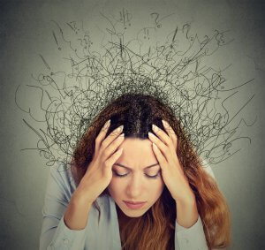 A woman holds her head as her hair appears to spread out in all directions. This could represent the anxiety from a tense situation. We offer anxiety counseling in Scotch Plains, NJ to support those struggling with anxiety and rage.