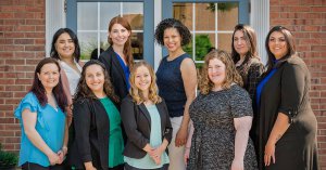 A group of therapists standing in front of a building