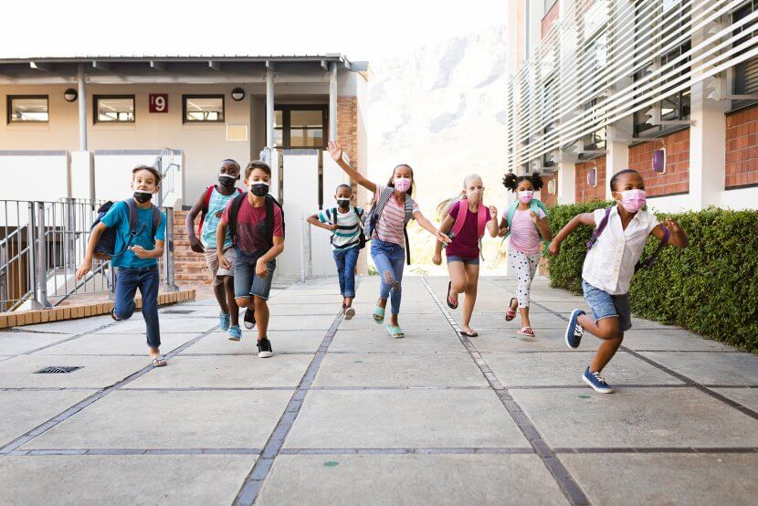 Diverse school age children wear masks while leaving a New Jersey School. Get counseling for childhood anxiety counseling in Scotch Planes, NJ at Brave Minds Psychological Services