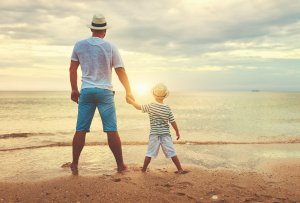 A father holds their child's hand as they watch the setting sun. This could represent the calm that anxiety counseling in Scotch Plains, NJ can help you and your child achieve. Contact a child therapist to learn more about child therapy for anxiety, anxiety treatment, and other services. 