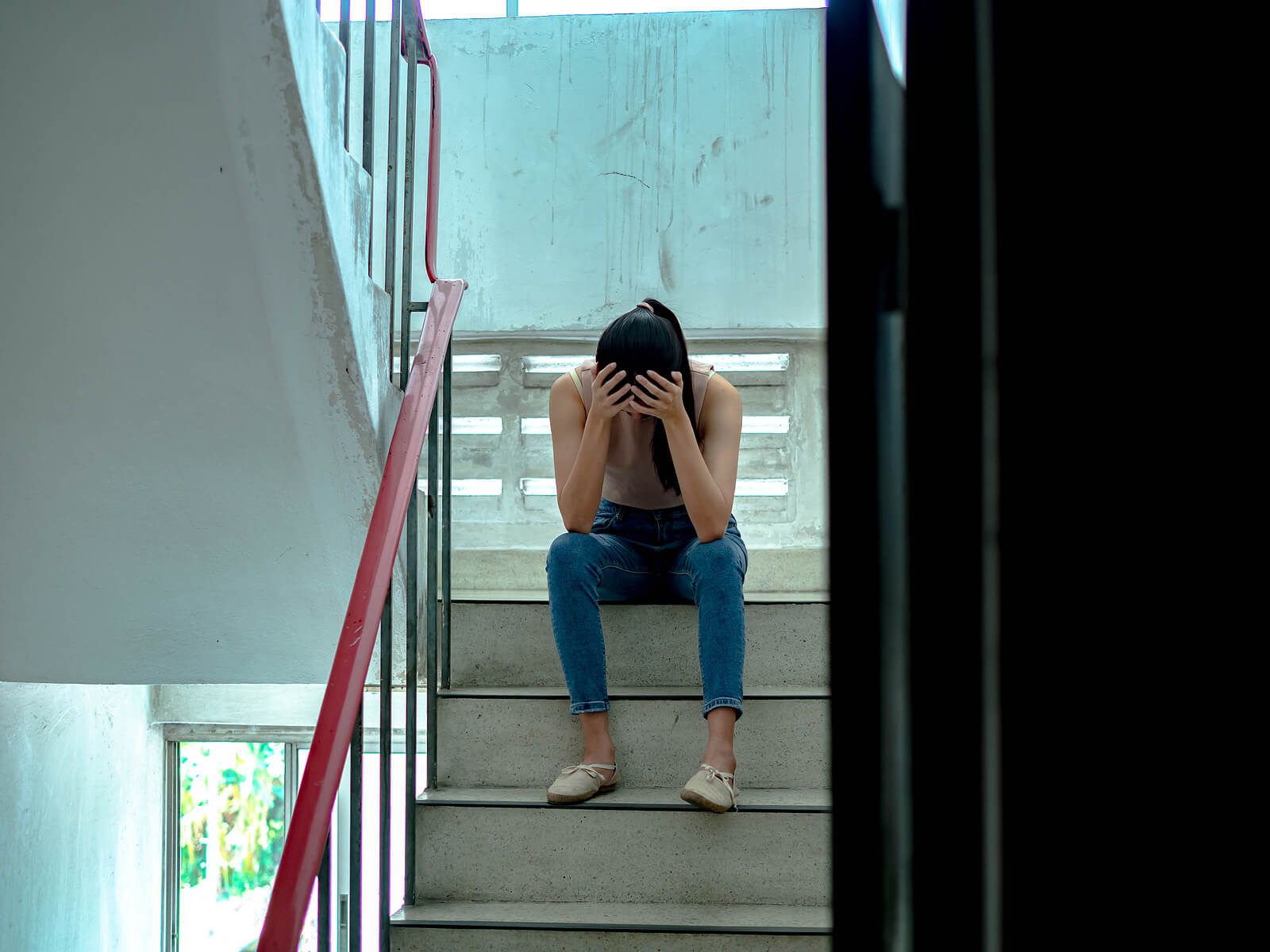 upset teen with head in her hands. Get support with child therapy and parenting counseling in Scotch Plains, NJ. Contact a parent coach for support with parenting help in Scotch Plains, NJ.