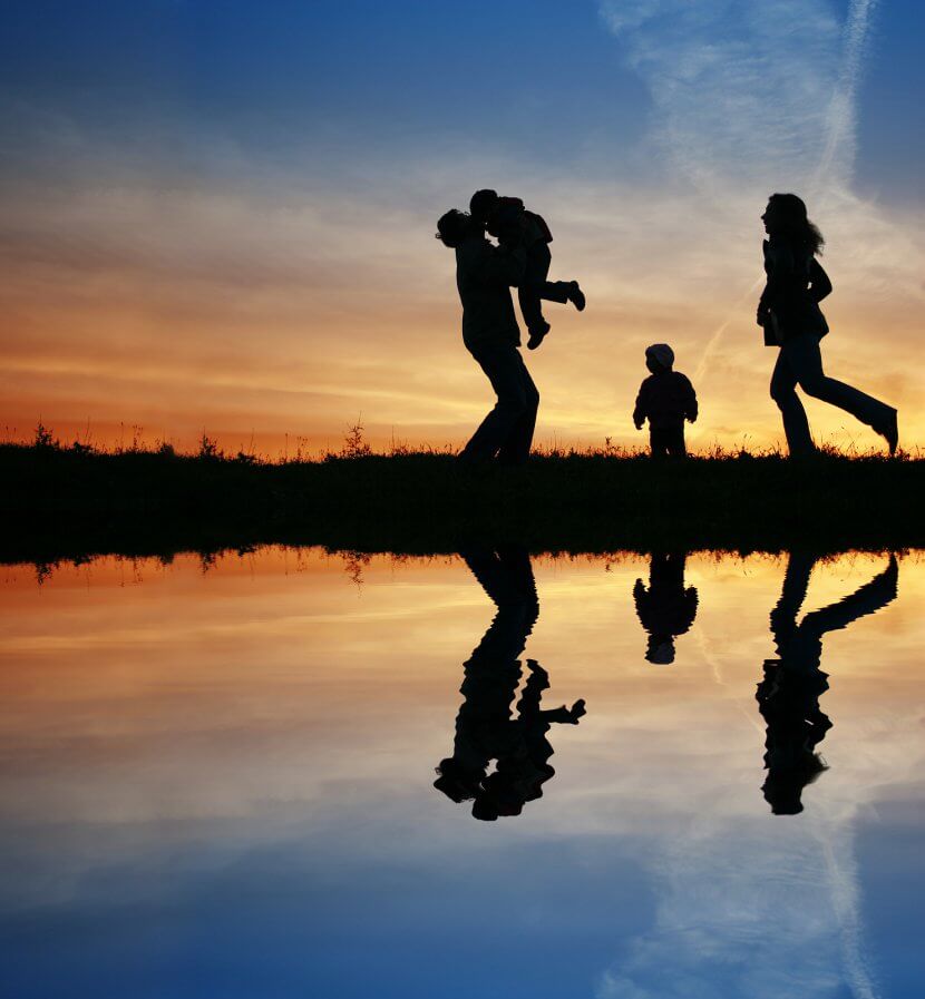 A silhouette of a family walk across the water as the sun rises. Contact brave minds psychological services to learn more about sexual violence prevention in Scotch Plains, NJ, parent counseling in Scotch Plains, NJ and other services.