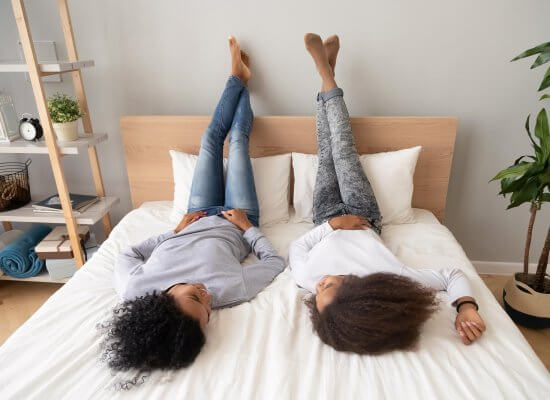 A mom and teen girl talk to one another as they lay on a bed. this could represent receiving support with sexual violence prevention in Scotch Plains, NJ today. Online therapy for sexual assault in New Jersey can offer you sexual violence support today. 07076