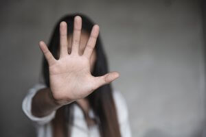 photo of a woman holding out her hand as if saying stop. Read more about talking to your children about rape culture from a trauma therapist in Scotch Planes, NJ