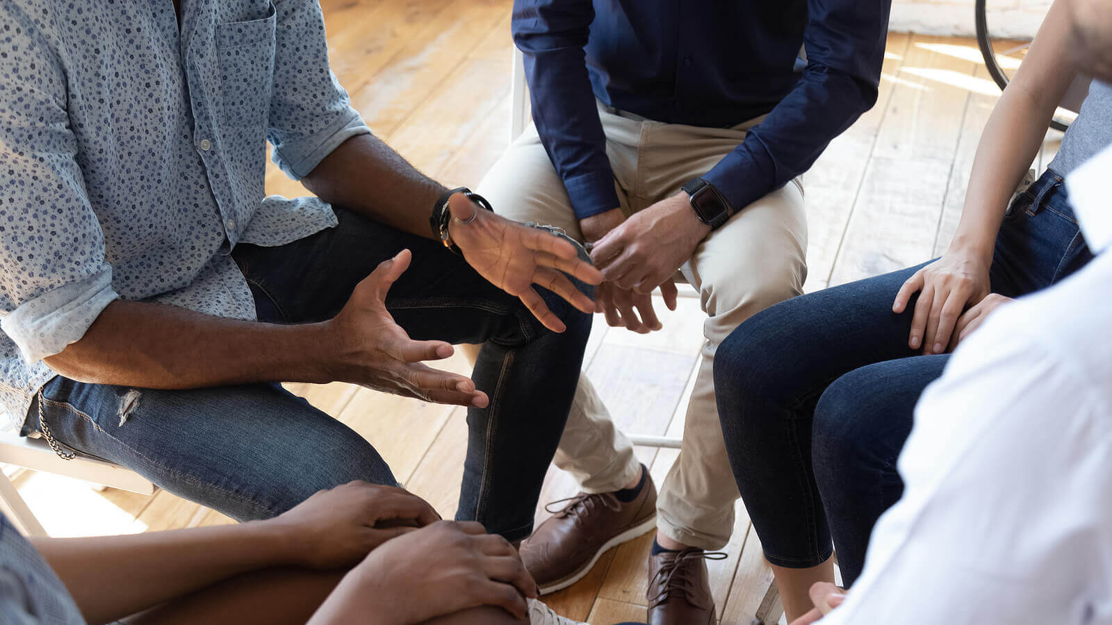 Group of people sitting in a tight circle to represent how group therapy can help teens with food allergies new jersey.