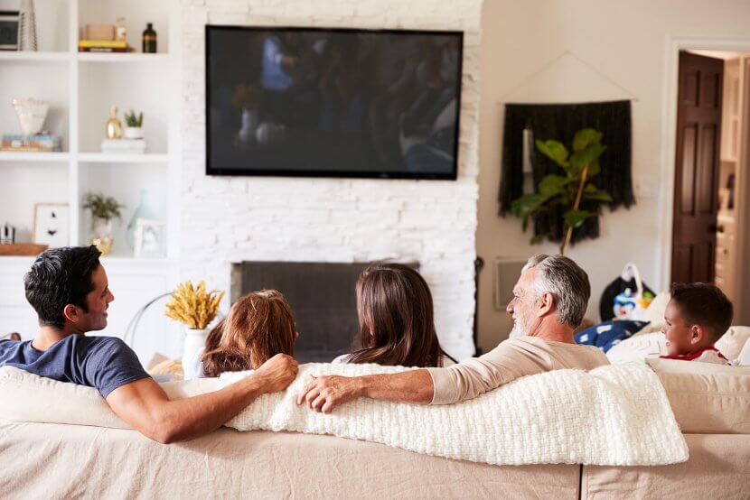 Image of a diverse family of 5 sitting on a couch laughing together. Don't let the narcissistic cycle continue. We can your whole family with trauma therapy and EMDR therapy for children in Scotch Plains, NJ 07016.