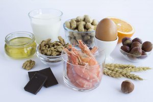 Image of a several food items in front of a white background. For parents food allergies and anxiety go hand in hand. An online therapist can healp you address fears of anaphylactic reaction in New Jersey 07076.