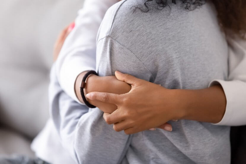 Image of a mother hugging her daughter. If you teen experienced dating violence online therapy for teens in New Jersey can help. We have give you parenting help on what to do next. Call today to talk to a teen counselor for parenting advice in Scotch Plains, NJ 07076. Connect with us today.