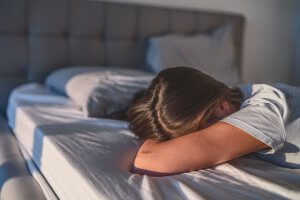 Image of an upset teen laying on a bed. A teen counselor advises about the many different types of teen dating abuse. Getting parenting advice and parenting help can help you catch the warning signs. If you are worried about your teenager we provide counseling for teens in Scotch Plains, NJ. Call today to find out more.