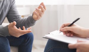 Image of the hands of a person speaking with a therapist. Which shows that Scotch Plains therapy interns are here to support you with counseling just like licensed therapists.
