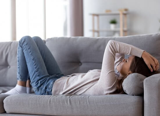 A teen lays on a couch with a tired expression. Their expression could represent the pain counseling for teens in Scotch Plains, NJ can offer support in overcoming. for you and your relationship with your teen. Learn how online therapy for teens can offer support today.