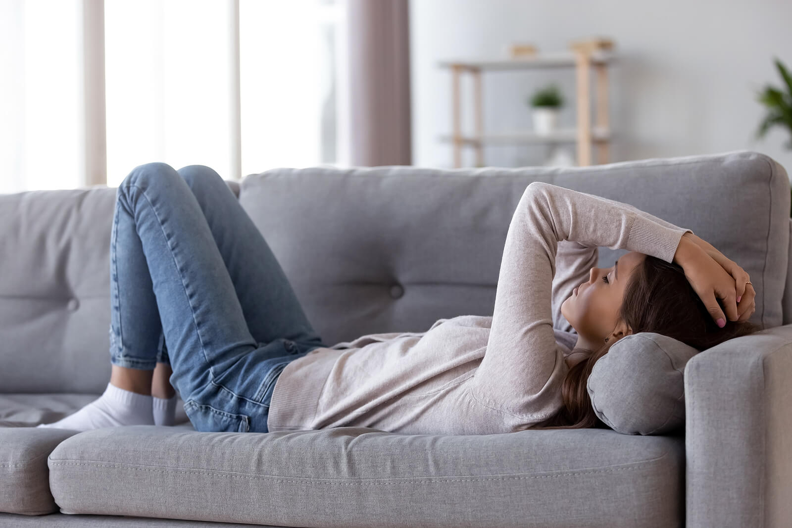 A teen lays on a couch with a tired expression. Their expression could represent the pain counseling for teens in Scotch Plains, NJ can offer support in overcoming. for you and your relationship with your teen. Learn how online therapy for teens can offer support today.