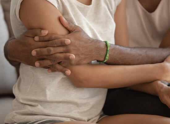 A close up of a person hugging a family member. Learn how parent coaching in Scotch Plains, NJ can offer support in addressing hard topics. Contact a trauma therapist in Scotch Plains, Nj for support with trauma therapy in Scotch Plains, NJ and more.