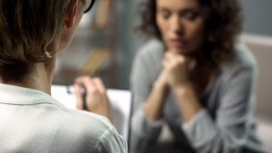 A person with a clipboard sits across from a woman while taking notes. Learn how a trauma therapist in Scotch Plains, NJ can offer support with equestrian related trauma therapy in Scotch Plains, NJ today. Learn more about trauma therapy in Scotch Plains, NJ and more. 