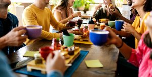 A group of people sit around a dinner table while talking to each other. This could represent the support anxiety treatment can offer in overcoming food allergies and anxiety. Search for signs of anxiety in Westfield, NJ to learn more today. 