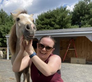 Elaine Harrison-Yau smiles at the camera for a headshot. Represents how counseling for teens in scotch plains, nj can incorporate equestrian therapy to help heal trauma.