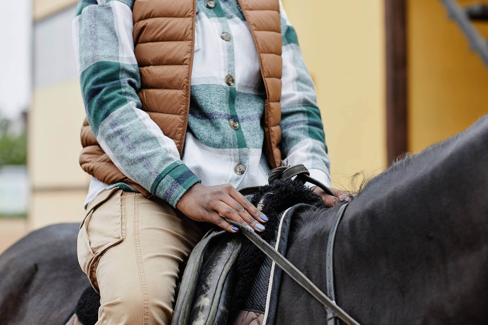 Shows an individual riding a horse in equestrian therapy. Represents how equestrian therapy in new jersey will support you with your equestrian related trauma.