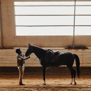 A horse rider stands in front of their horse while holding their reigns. This could represent the support equestrian related trauma therapy in Scotch Plains, NJ can offer with overcoming equestrian related stress. Contact a trauma therapist in Scotch Plains, NJ to learn more today.
