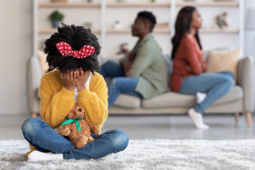 A child sits with their head down as their parents sit facing away from one another. This could represent the trauma a trauma therapist in Scotch Plains, NJ can help you overcome. Learn more about trauma therapy in Scotch Plains, NJ by searching for a trauma therapist near me.