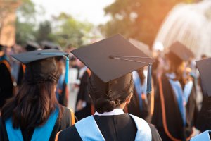 A close up of a group of new college graduates in cap in gown. Learn more about the support a perfectionism therapist in Scotch Plains, NJ can offer support with addressing burnout and balance. Westfield NJ counseling can offer support via online therapy for college students in New Jersey today.