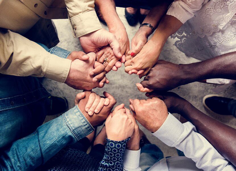 A top down view of the hands belonging to people sitting in a circle. Learn how a culturally sensitive therapist in scotch plains or branchburg, nj can offer support with signs of anxiety in Westfiled and Somerville, NJ. Search for a trauma therapist near me to learn more.