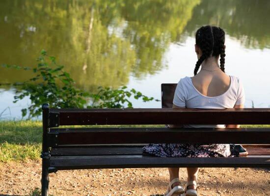 Image of a a teenage girl sitting on a bench. Which represents someone who could benefit from therapy for teens, or adolescent therapy in Branchburg, NJ. Where anxiety in teens can be addressed.