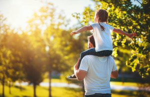 Man holds girl on his shoulders while at a park. Wanting to take the first steps to a better life for you and your child in New Jersey? Our child therapy helps your child become the best version of themselves, call today!
