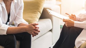 One Person with a Clipboard, Another Person Sitting Down on Couch. Looking for a way to move forward from your trauma? Trauma therapy in Branchburg, NJ can help you become a better version of yourself. Speak to a trauma therapist today!